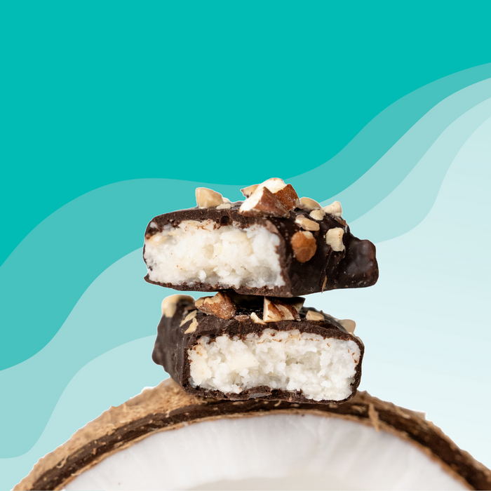 Dark chocolate Coconut filled snakcs with almonds on a teal background