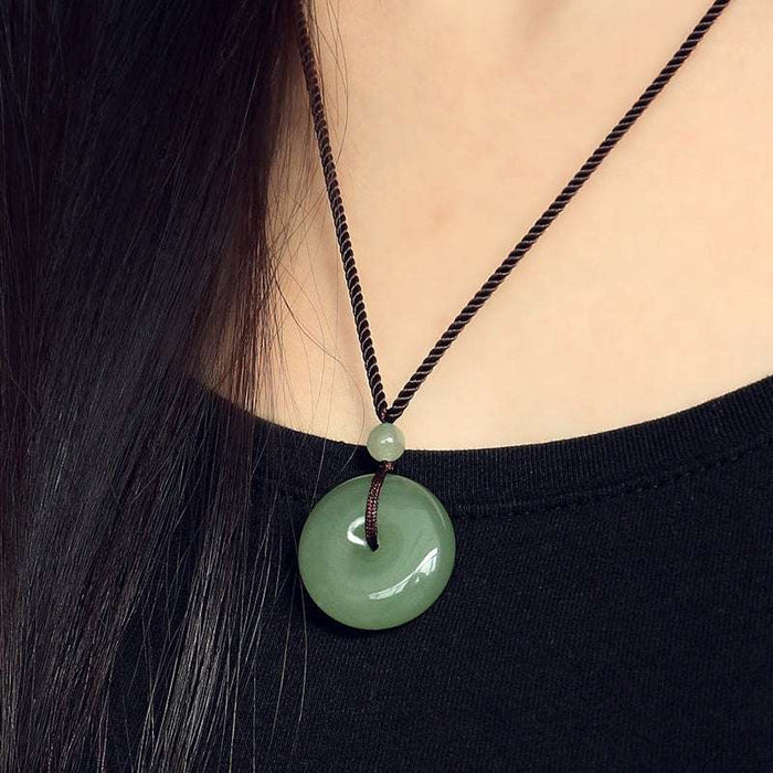 Woman wearing natural jade donut pendant necklace