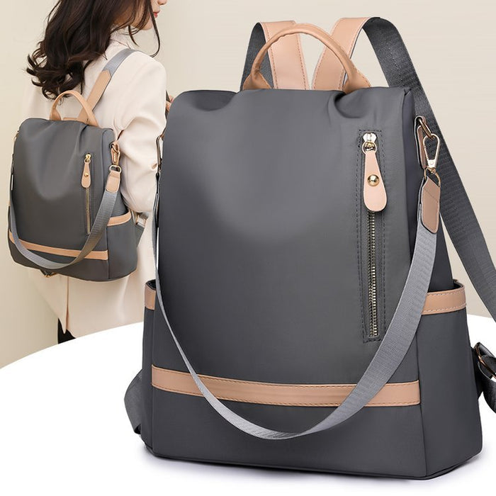 A large capacity backpack in dark gray with a milky white stripe, featuring a front zipper pocket and adjustable straps.
