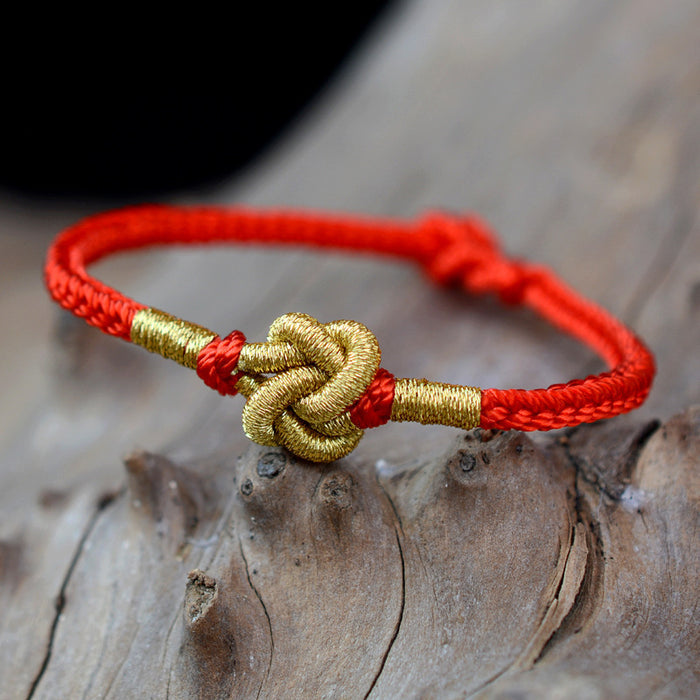 handmade red string bracelet with golden money knot charm