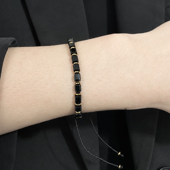 Natural black obsidian protection bracelet with square gemstone beads wear on a wrist