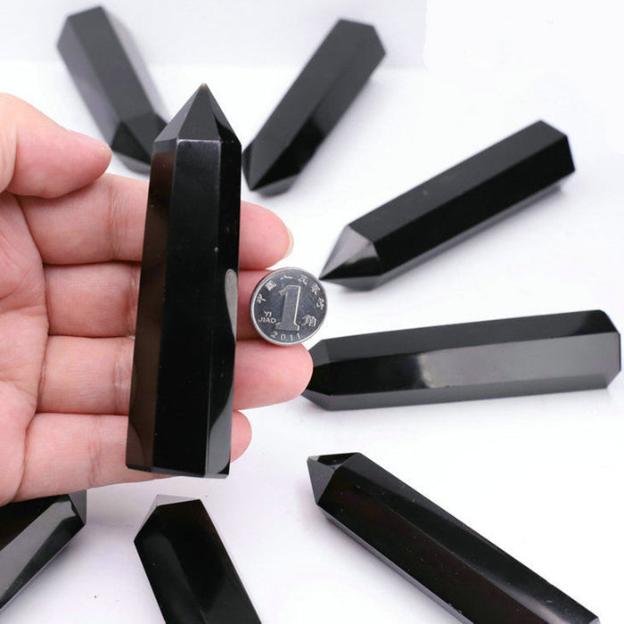 Deep glossy black obsidian crystal point on desk décor