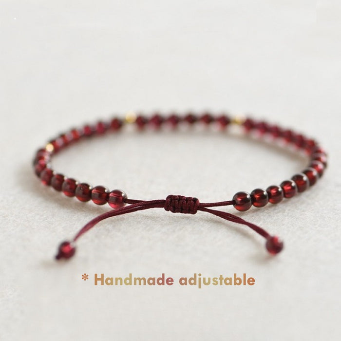 Close-up of 4 mm natural red garnet beads and gold spacers