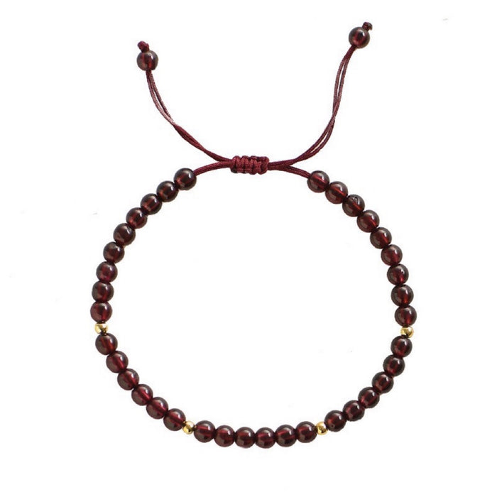 Close-up of 4 mm natural red garnet beads and gold spacers