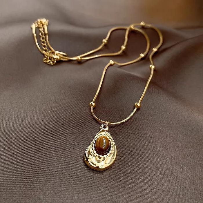Close-up of genuine Tiger’s Eye gemstone pendant – shimmering golden-brown stone