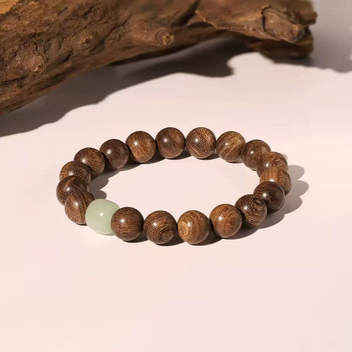 Handcrafted wooden bead bracelet featuring a genuine Hetian Jade centerpiece