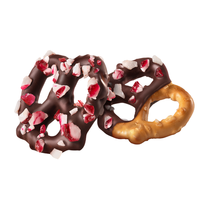 Two dark chocolate covered pretzels with peppermint pieces on a white background