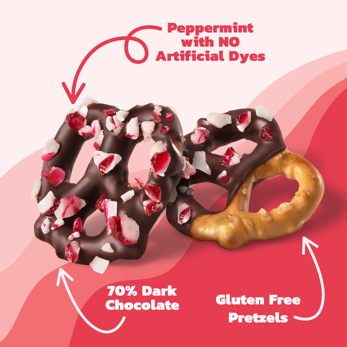 Chocolate-dipped pretzel with peppermint pieces on a pink background, labeled with ingredients and no artificial dye information.