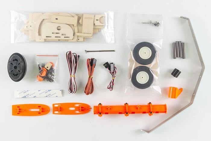 DIY drone kit with orange frame, wheels, motors, and electronics for UAV assembly and mapping projects