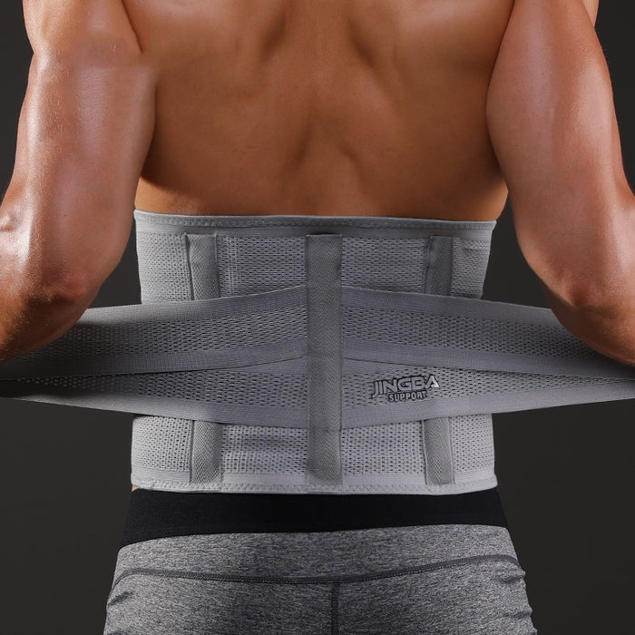 Person wearing a gray back brace against a dark background